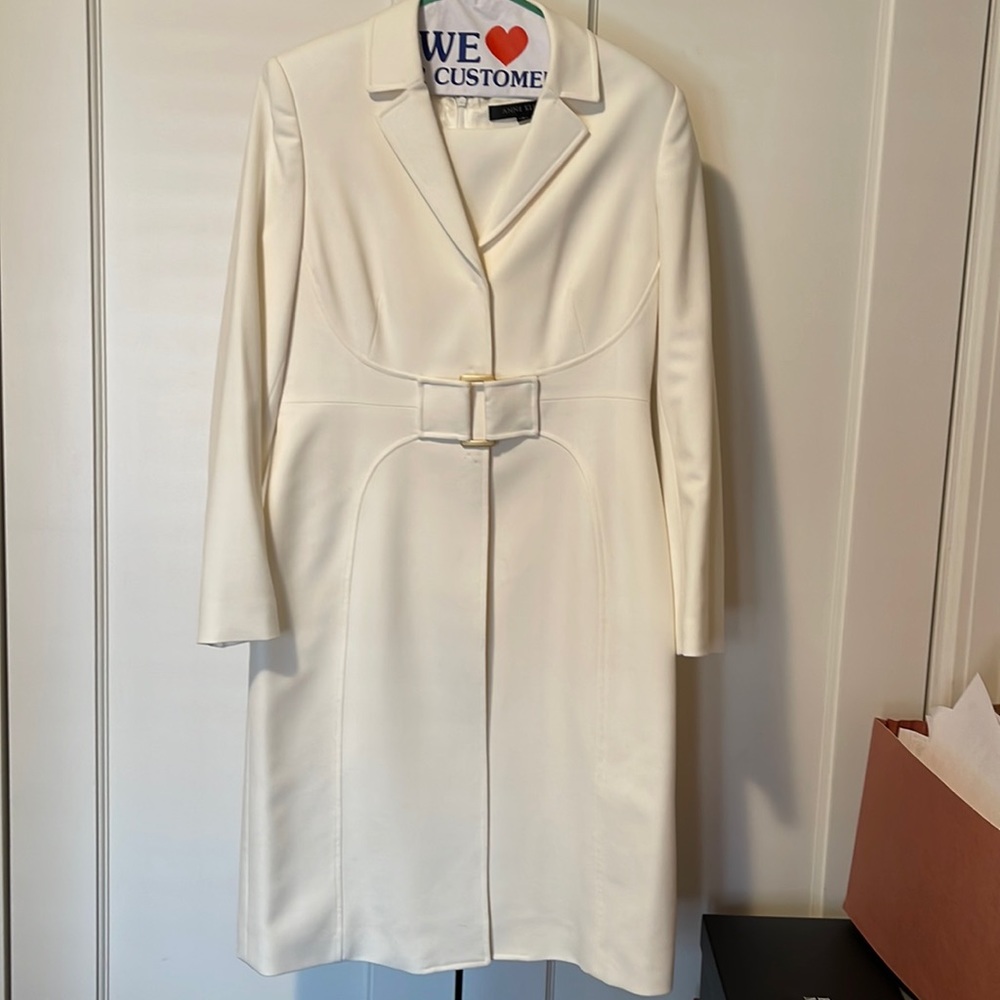 Ivory gabardine dress and matching dress-length jacket/coat with gold buckle.